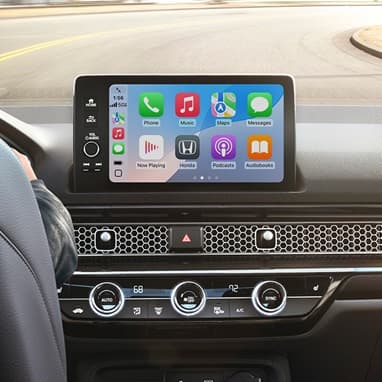 2026 Honda Civic Hatchback Sport Touring Hybrid dashboard with screen displaying Apple CarPlay (Compact Hatchback).