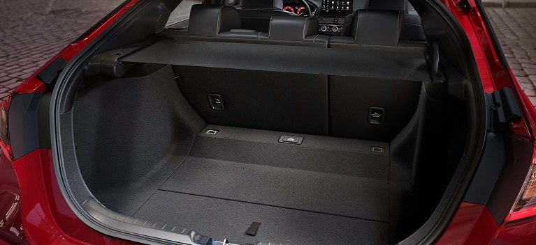 2027 Honda Civic Hatchback Sport Touring Hybrid spacious cargo area with rear seats up and cargo cover (Compact Hatchback).
